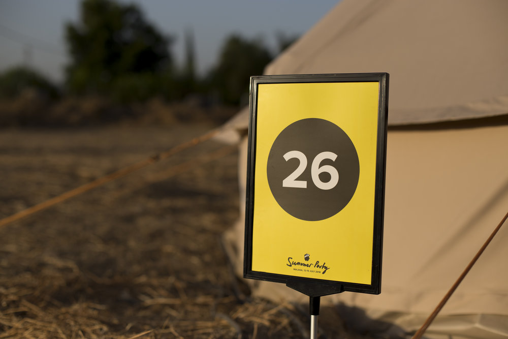 A yellow numbered post outside of a tent