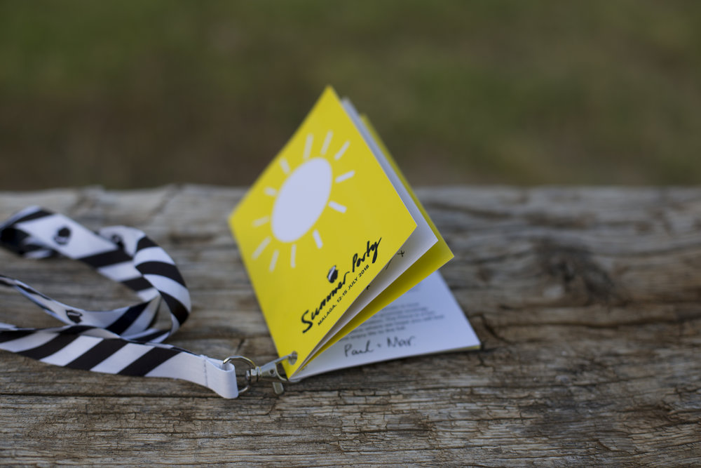A photo of the finished striped lanyard and the schedule booklet