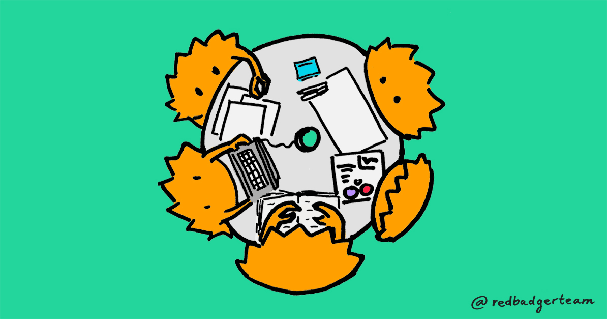A group of illustrated 'rustaceans' around a table with notes and a keyboard